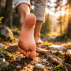 Fußsohle sichtbar, Person geht Barfuß durch den Wald und stimuliert so natürlich die Mechanorezeptoren auf der Fußsohle
